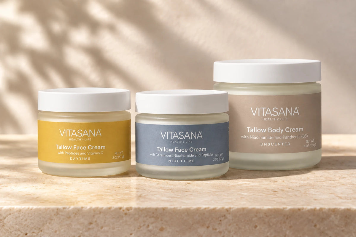 Vitasana Tallow Day Face Cream, Tallow Night Face Cream and Tallow Body Cream together on a warm stone surface